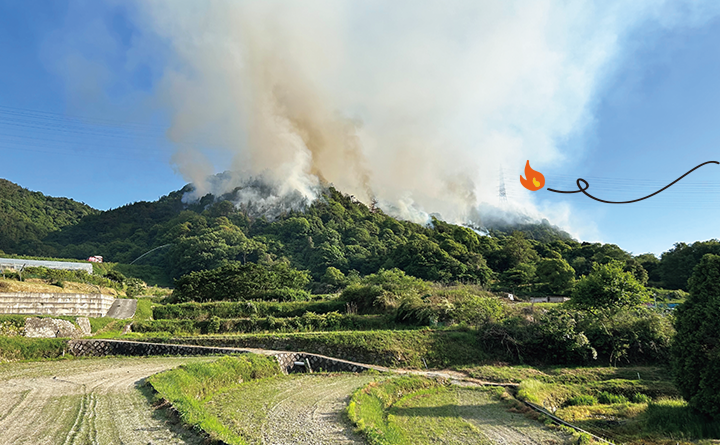 山火事で煙が出ている山の様子